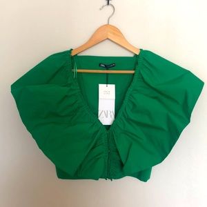 Green top with dramatic ruffled sleeves